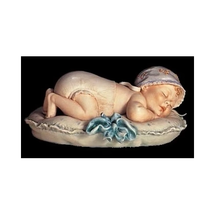 Zdjęcie Porcelanowy chłopczyk drzemiący na poduszce